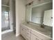 Bright bathroom with double vanity sinks, white countertops, and a glass-enclosed shower at 1312 Walter Taylor Way # Eqx0104, Charlotte, NC 28206
