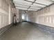 Spacious garage with concrete floors, ample space for storage, and a door at 1312 Walter Taylor Way # Eqx0104, Charlotte, NC 28206