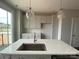Modern kitchen with gray cabinets, a large island with a sink, and stylish pendant lighting at 1312 Walter Taylor Way # Eqx0104, Charlotte, NC 28206