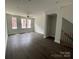 Bright living room with hardwood floors, multiple windows, and staircase at 1312 Walter Taylor Way # Eqx0104, Charlotte, NC 28206