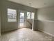 Unfinished room featuring plenty of natural light, neutral paint, and access to a small deck at 1312 Walter Taylor Way # Eqx0104, Charlotte, NC 28206