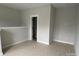 Neutral paint, white trim, and bright light characterize this spacious and unfinished bonus room at 1312 Walter Taylor Way # Eqx0104, Charlotte, NC 28206