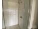 Bathroom shower featuring sleek white subway tile, glass door, and modern fixtures at 1312 Walter Taylor Way # Eqx0104, Charlotte, NC 28206
