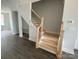 Newly constructed staircase features natural wood treads, white risers, and black metal balusters at 1312 Walter Taylor Way # Eqx0104, Charlotte, NC 28206