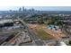 An aerial view of townhome construction set against a city skyline at 1316 Walter Taylor Way # Eqx0103, Charlotte, NC 28206