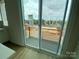 View of the outdoor balcony featuring sliding glass doors and metal railings providing a seamless indoor-outdoor flow at 1316 Walter Taylor Way # Eqx0103, Charlotte, NC 28206