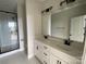 Modern bathroom with dual vanities, sleek fixtures, a glass-enclosed shower, and light tile flooring at 1316 Walter Taylor Way # Eqx0103, Charlotte, NC 28206