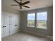 Bright bedroom with large windows, neutral paint, and double door closet, providing a serene living space at 1316 Walter Taylor Way # Eqx0103, Charlotte, NC 28206