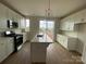 Modern kitchen showcasing white cabinets, a stainless steel range, and a central island at 1316 Walter Taylor Way # Eqx0103, Charlotte, NC 28206