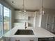 A well-lit kitchen features an island, white cabinets, and modern gold fixtures at 1316 Walter Taylor Way # Eqx0103, Charlotte, NC 28206
