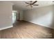 Open-concept living room with light vinyl flooring and neutral walls, offering ample space and natural light at 1316 Walter Taylor Way # Eqx0103, Charlotte, NC 28206