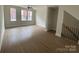 Bright living room with natural light from large windows, featuring neutral paint and modern ceiling fan at 1316 Walter Taylor Way # Eqx0103, Charlotte, NC 28206
