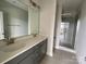 Modern bathroom with double sink vanity, sleek mirror, and glass-enclosed shower for a spa-like experience at 1320 Walter Taylor Way # Eqx0102, Charlotte, NC 28206