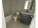 Well-lit bathroom features a sleek vanity with a gray cabinet and a shower-tub combo at 1320 Walter Taylor Way # Eqx0102, Charlotte, NC 28206