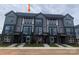Modern townhome exterior features gray siding, brick accents, and a well-manicured lawn at 1320 Walter Taylor Way # Eqx0102, Charlotte, NC 28206