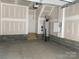 Clean two-car garage featuring high ceilings and ample storage space for vehicles at 1320 Walter Taylor Way # Eqx0102, Charlotte, NC 28206