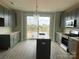 Kitchen featuring gray cabinets, stainless steel appliances, quartz countertops, and island sink at 1320 Walter Taylor Way # Eqx0102, Charlotte, NC 28206