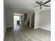 Bright, open living area with gray flooring, modern ceiling fan, and view of the kitchen and staircase leading upstairs at 1320 Walter Taylor Way # Eqx0102, Charlotte, NC 28206
