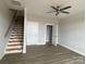 Cozy living room with modern gray flooring, staircase, ceiling fan, and neutral walls creating a blank canvas at 1320 Walter Taylor Way # Eqx0102, Charlotte, NC 28206