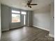 Bright living room featuring a large window, modern gray flooring, and neutral walls, offering a comfortable living space at 1320 Walter Taylor Way # Eqx0102, Charlotte, NC 28206