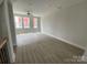 Spacious living room with natural light from large windows and gray floors, creating a modern and inviting atmosphere at 1320 Walter Taylor Way # Eqx0102, Charlotte, NC 28206
