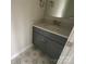Powder room with grey vanity and decorative floor tiles at 1324 Walter Taylor Way # Eqx0101, Charlotte, NC 28206