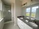 Bright bathroom featuring a double sink vanity with gray countertops and a walk-in shower at 1324 Walter Taylor Way # Eqx0101, Charlotte, NC 28206