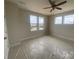 Bright bedroom with three large windows and beige walls; new construction at 1324 Walter Taylor Way # Eqx0101, Charlotte, NC 28206