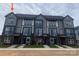 Modern townhome exteriors with large windows and brick accents for stylish curb appeal at 1324 Walter Taylor Way # Eqx0101, Charlotte, NC 28206