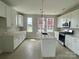Spacious kitchen with white cabinets, marble countertops, and stainless steel appliances at 1324 Walter Taylor Way # Eqx0101, Charlotte, NC 28206