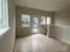 Open living room with door to outdoor patio at 1324 Walter Taylor Way # Eqx0101, Charlotte, NC 28206