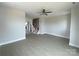 Spacious living room with light vinyl flooring, a ceiling fan, and white trim throughout at 1324 Walter Taylor Way # Eqx0101, Charlotte, NC 28206