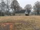 Large backyard with shed and distant view of the house at 13410 Old Camden Rd, Midland, NC 28107