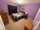 Cozy bedroom with purple walls and carpeted floors at 13410 Old Camden Rd, Midland, NC 28107