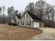 Gray house with black shutters, a black roof, and a detached garage at 13410 Old Camden Rd, Midland, NC 28107