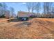Back of the house with access to a garage door on the basement level at 150 Windmill Ct, Harmony, NC 28634
