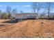 Rear exterior showing siding and a deck with stairs leading to the yard at 150 Windmill Ct, Harmony, NC 28634