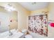 Cozy bathroom with a tub and shower, a patterned shower curtain, and vanity mirror at 150 Windmill Ct, Harmony, NC 28634