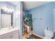 Light blue bathroom with a tub and shower, a star fish shower curtain, and vanity mirror at 150 Windmill Ct, Harmony, NC 28634