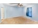 Light blue bedroom features a ceiling fan and curtained window, offering a relaxing space at 150 Windmill Ct, Harmony, NC 28634
