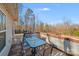 Back deck featuring an outdoor dining set and a view of the wooded surroundings at 150 Windmill Ct, Harmony, NC 28634