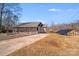 Exterior view showcasing the side of the home, driveway, and solar panel at 150 Windmill Ct, Harmony, NC 28634
