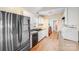 Well-lit kitchen with stainless steel appliances, granite countertops, and a convenient laundry area at 150 Windmill Ct, Harmony, NC 28634