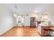 Open-concept living area with hardwood floors connecting to a modern kitchen with stainless steel appliances and an island at 150 Windmill Ct, Harmony, NC 28634