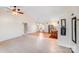 Open-concept living space with abundant natural light, tiled flooring, and modern ceiling fan with elegant chandelier at 150 Windmill Ct, Harmony, NC 28634