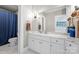 Elegant bathroom with marble vanity, white cabinets, and a shower with blue curtain at 18805 Flat Shoals Dr, Cornelius, NC 28031