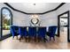 Formal dining room with blue velvet chairs and a modern chandelier at 18805 Flat Shoals Dr, Cornelius, NC 28031