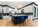 Modern kitchen with white cabinets, granite countertops, and stainless steel appliances at 18805 Flat Shoals Dr, Cornelius, NC 28031
