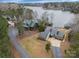 Aerial view of waterfront property showcasing main house and a neighboring home at 192 Diana Dr, Mount Gilead, NC 27306