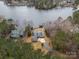 Aerial view of waterfront property with two houses and a private dock at 192 Diana Dr, Mount Gilead, NC 27306